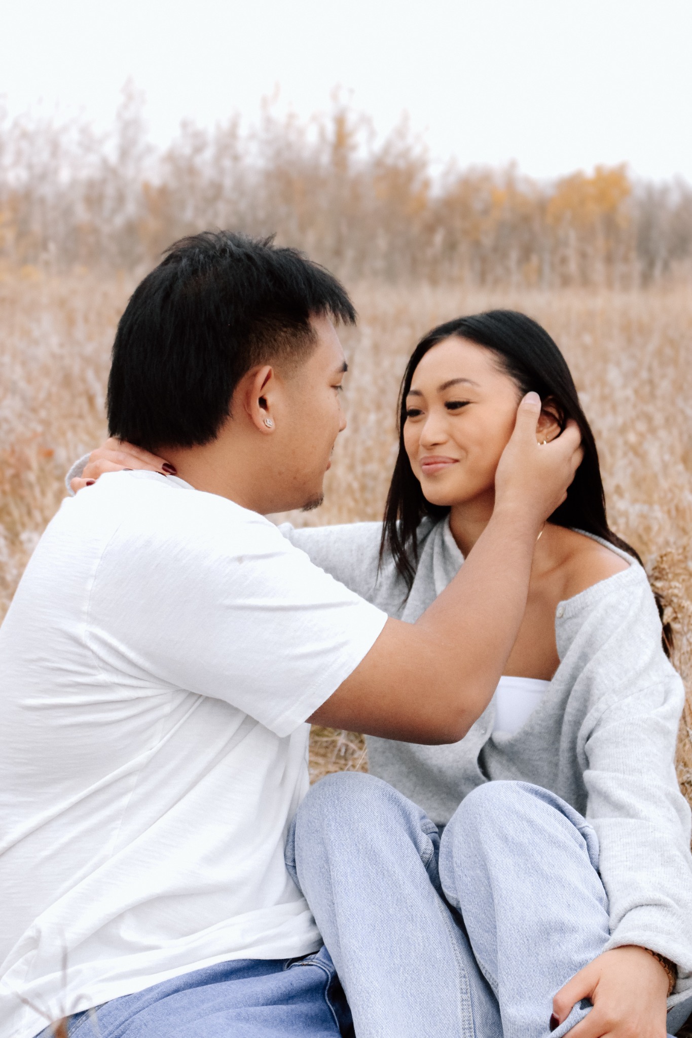 An engaged couple sharing a quiet moment in the prairie