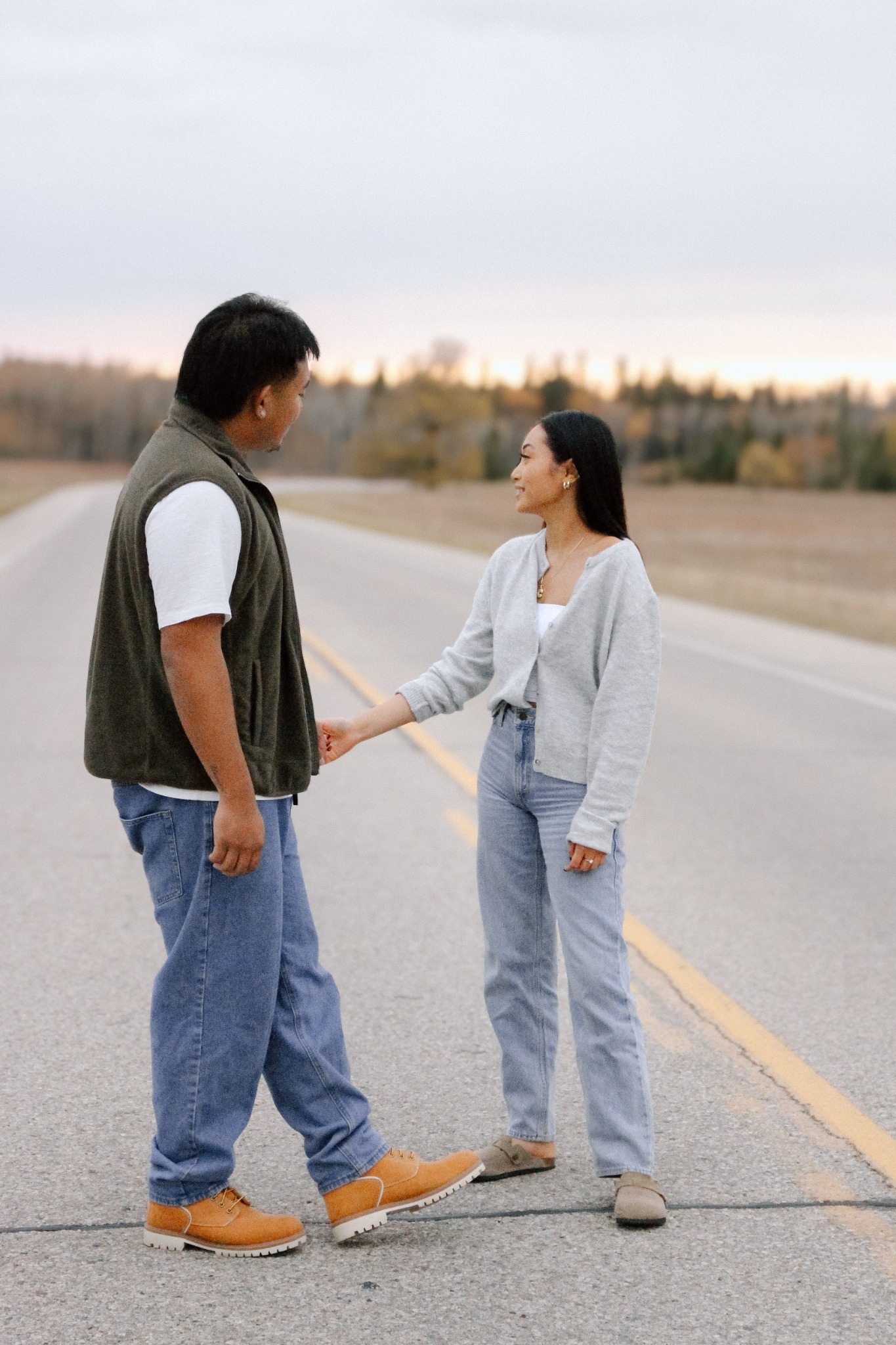 A couple holding hands on a quiet road